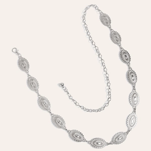 Detail of silver alloy waist chain featuring embossed oval plates and lobster clasp