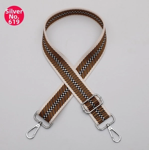 Detail of silver swivel hook on ethnic style black and orange checkered woven bag strap