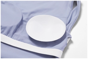 Detail of lavender yoga top featuring removable white pads and breathable mesh lining