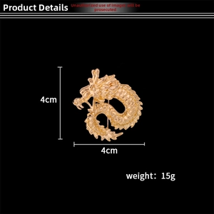 Detailed view of golden dragon brooch showing 4cm size and intricate metallic carving