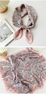 Detail of pink silk-satin scarf with paisley pattern and celestial astrological border