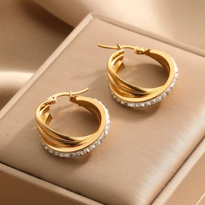 Three-layer gold hoop earrings with sparkling rhinestones on a champagne velvet box