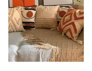 Boho tufted cushion covers with tassels and geometric knit sofa throw in warm earthy tones