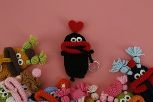 Detailed knit texture of handmade cartoon key covers in multiple vibrant colors