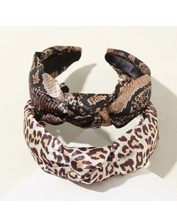 Detail shot of leopard and snake print twist headbands with satin texture on display