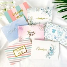 Detailed view of assorted thank you cards with floral designs on white fabric