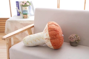 Detailed close-up of a realistic mushroom plush pillow on a beige fabric sofa
