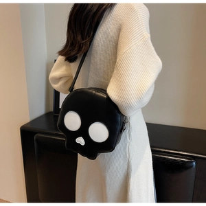Detail of creative skull-shaped crossbody bag featuring white eyes and heart-shaped nose