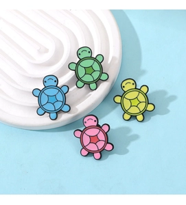 Macro shot of colorful enamel turtle brooches in blue, green, yellow and pink