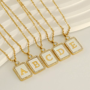 Square shell letter pendant necklace with gold plating and cubic zirconia borders