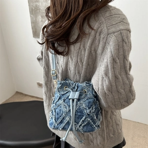 Blue tie-dye denim bucket bag with frayed quilted patterns and drawstring closure for women