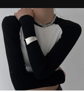 Close-up of irregular silver fluid-style wide cuff bracelet and chunky chain necklace