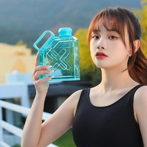 Detail of lake blue square fitness water bottle with X-shape groove and handle
