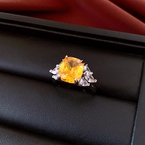 Detailed close-up of French palace style silver ring with a large yellow cushion-cut stone