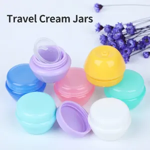 Set of multi-colored mushroom-shaped cream jars for travel cosmetic packaging