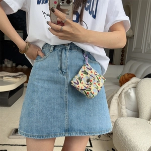 Mini floral canvas pouch with purple tulips worn on belt loop of denim skirt