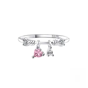 Macro detail of S925 sterling silver ring showing pink heart and clear teardrop charms