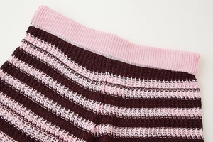 Detail of pink and brown striped knit shorts featuring a textured elastic waistband