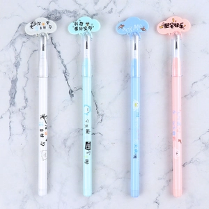 Flat lay of four colorful cloud-shaped cap pens with funny text on marble surface