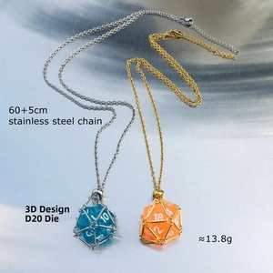 Detail of 3D D20 dice pendants in silver and gold cages with stainless steel chains
