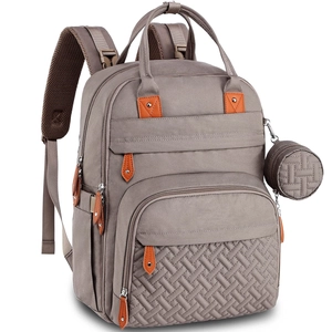 Detail of grey baby diaper backpack with side pockets and a small round woven pouch