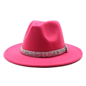 Detailed view of the sparkling crystal rhinestone band on a rose red wool jazz fedora hat