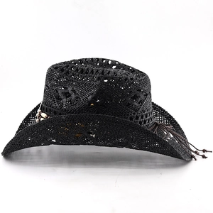 Detail of black woven cowboy straw hat with vintage wooden beads and tassel trim