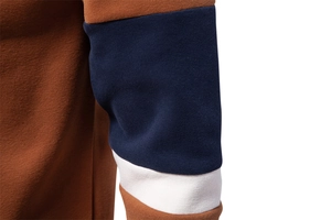 Detail of color-block sleeve stitching on a high-quality knit polo sweatshirt