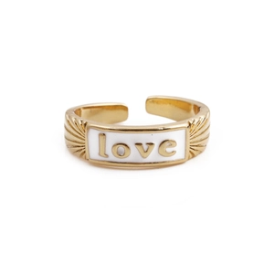 Close-up of golden open ring featuring white enamel surface and love engraving