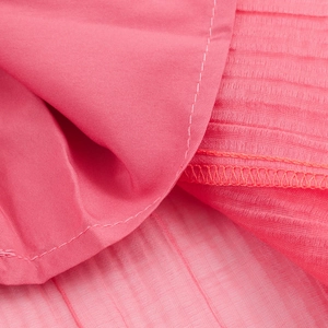 Detail shot of pink pleated bohemian two-piece set fabric showing soft chiffon texture