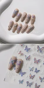 Detailed view of aurora butterfly nail stickers with pearls and crystals on nude nails