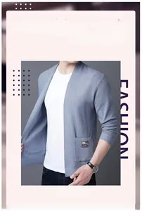 Detail of grey-blue knit cardigan with V-neckline and small branded square patch on pocket
