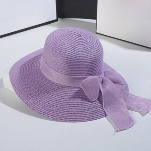Close-up of purple woven sun hat featuring a delicate fabric bow and fine texture
