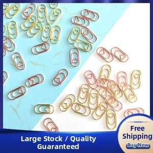 Macro shot of creative heart-shaped paper clips in gold and rose gold metal finishes