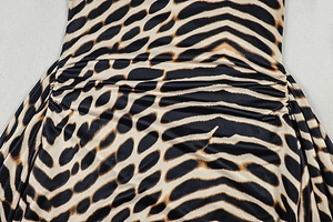 Detail of the leopard print dress showing the gathered side ruched design and texture
