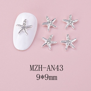 Detailed view of silver starfish nail charms with 9x9mm dimensions and crystals