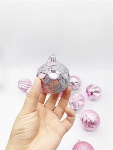 Macro shot of assorted pink Christmas ornaments with glitter and embossed textures