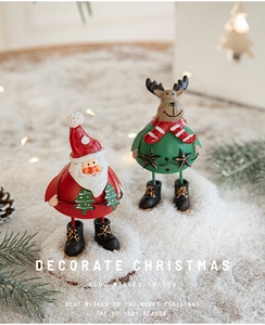 Close-up of Santa Claus and Reindeer Christmas iron figurines on snow display