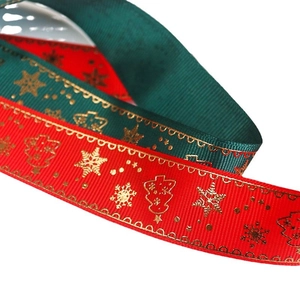Christmas ribbed ribbon with gold snowflake and tree patterns in red and green colors