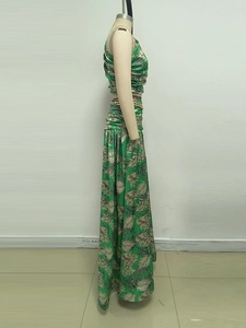 Detail of two-piece green palm leaf print dress with cropped top and maxi skirt