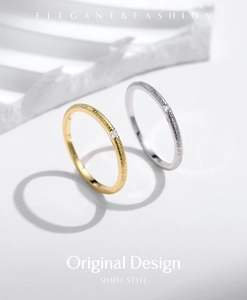 Detail of silver and gold rings with irregular textures and sparkling diamond accents
