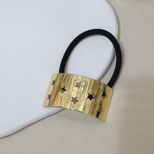 Minimalist U-shaped hair tie with golden brushed metal star pattern on an elastic band