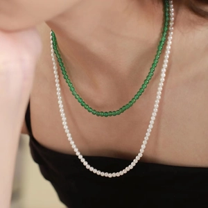 Close-up of double-layer layered necklace with green chalcedony beads and white pearls