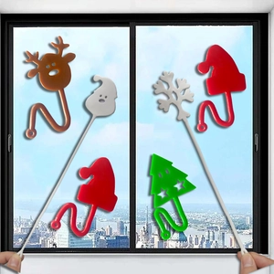Sticky TPR Christmas figures including Santa hat, reindeer and tree on a window surface