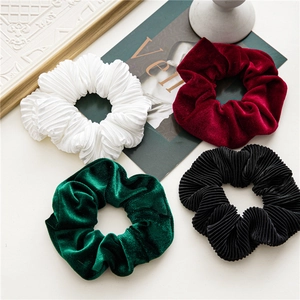 Set of four pleated and velvet scrunchies in autumn colors for elegant hair styling
