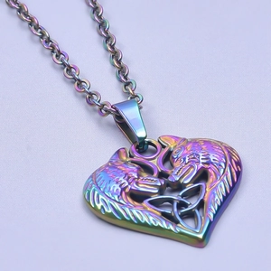 Macro shot of rainbow-colored heart wolf pendant with intricate Celtic knot patterns