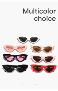 Array of oversized cat eye sunglasses in seven vibrant colors on white background