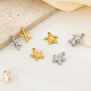 Detailed view of gold and silver starfish and turtle charms for DIY ocean jewelry