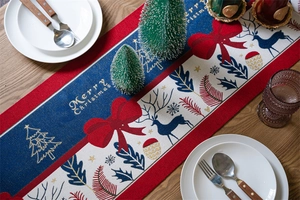 Close-up of Merry Christmas jacquard table runner with reindeer and bow patterns