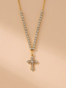 Detailed view of a gold cross pendant necklace featuring shimmering rhinestone inlay